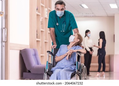 Assistance Doctor Staff Help Senior Patient Wear Protective Face Mask And Sit On Wheelchair After Recovering From Cancer Treatment With Cremo Therapy In The Hospital