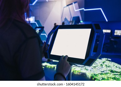 Assistant And A Blank Large Display Of A Professional Tablet On A Computer Game Event Or Exhibition. Concept Of Digital Assistance, Type Your Text.