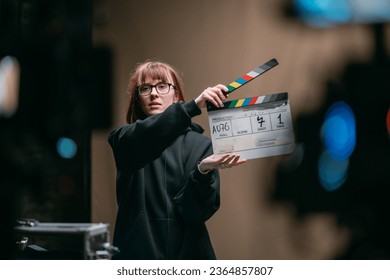 Assistant director with clapperboard on set. Close-up of firecrackers for filming a movie, advertising, TV series. Modern photography technique.