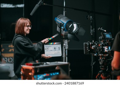 Assistant director with clapperboard on set. Close-up of firecrackers for filming a movie, advertising, TV series. Modern photography technique.