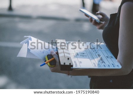 Assistant director with clapperboard on set. Close-up of firecrackers for filming a movie, advertising, TV series. Modern photography technique.
