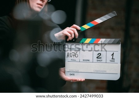 Assistant director with clapperboard on set. Close-up of firecrackers for filming a movie, advertising, TV series. Modern photography technique.