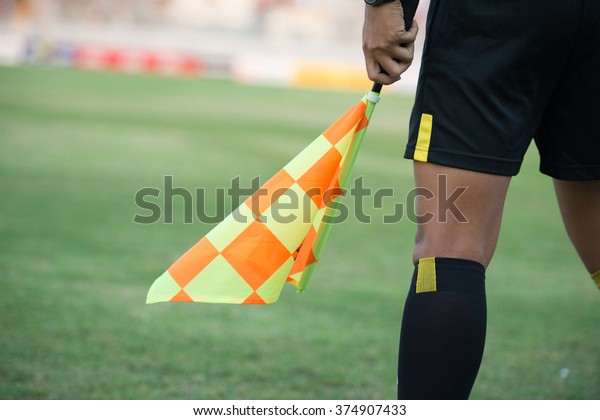 Assistant football\
referee and Referee\'s\
flag