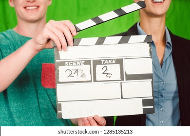 Assistant Holds Movie Slate Into The Camera To Start The Production Of A Video Piece