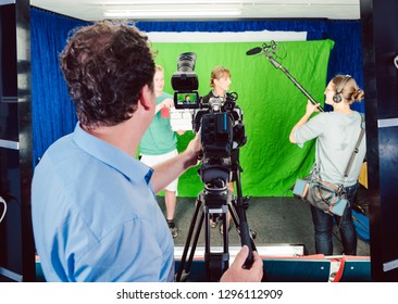 Assistant Holds Movie Slate Into The Camera To Start The Production Of A Video Piece