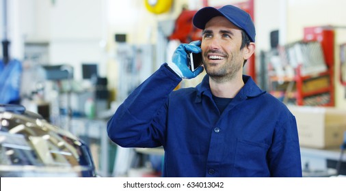 Assistant mechanic calls customers for communication, in the background of the car service center. Concept repair of machines fault diagnosis repair specialist, technical maintenance on-board computer - Powered by Shutterstock