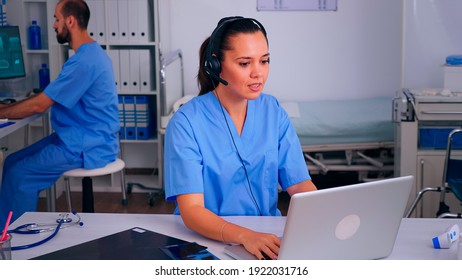 Assistant offering medical online services using headphone answering calls, making appointments. hospital call center Healthcare physician in medicine clinic, receptionist doctor nurse helping with - Powered by Shutterstock