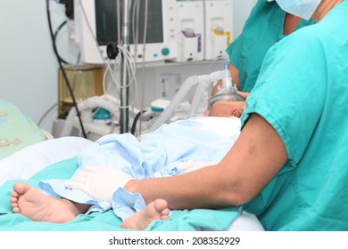 Assistant Preparing A Child For A Surgery