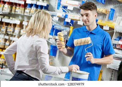 Assistant Seller Help Buyer By Demonstrating Paint Roller For Painting At Hardware Store