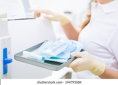 Assistant with sterile dentist tools  - Shutterstock ID 194793584