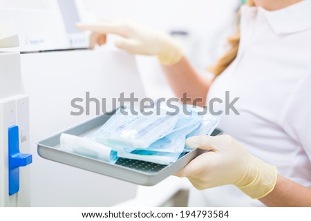 Assistant with sterile dentist tools 