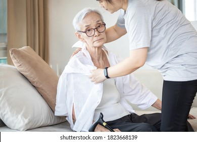 Assisting in dressing,asian female caregiver taking care of helping senior woman get dress,chang clothes for old mother,Alzheimer's elderly patient sit on the sofa at home,preparing go to the hospital - Shutterstock ID 1823668139