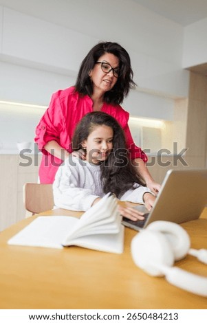 Assisting with homework while nestled in the warmth and comfort of a cozy living room on a bright, sunny afternoon