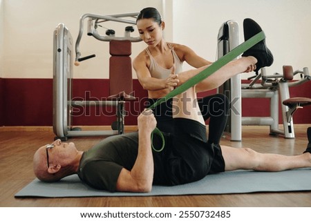 Assisting Senior with Stretching Exercise Using Resistance Band