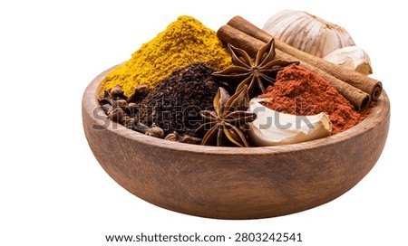 Assorted aromatic spices and garlic cloves in a rustic wooden bowl