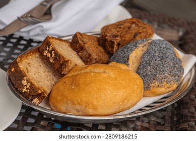 Assorted Artisan Bread Rolls and Sliced Loaves Served in a Bread Basket
