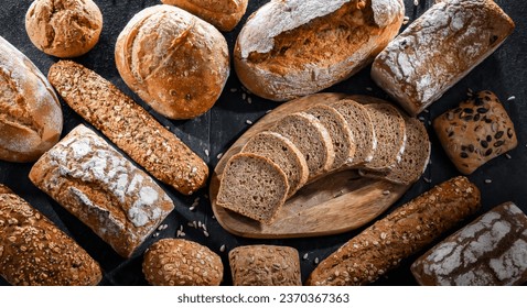Assorted bakery products including loaves of bread and rolls - Powered by Shutterstock