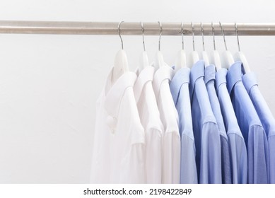 Assorted Blue ,white Dress Shirts Hanging On Hangers