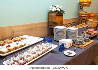 Assorted Breakfast Buffet Spread with Fresh Pastries and Fruits in hotel