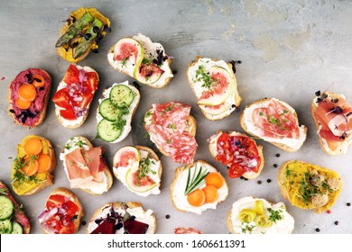 Assorted Bruschetta With Various Toppings. Appetizing Bruschetta Or Brie Crostini. Variety Of Small Sandwiches. Mix Bruschetta