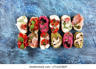 Assorted Bruschetta With Various Toppings. Appetizing Bruschetta Or Crudo Crostini. Variety Of Small Sandwiches. Mix Bruschetta