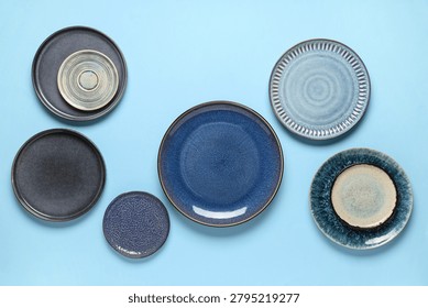Assorted ceramic dinnerware collection on blue background, modern kitchen and dining table setting