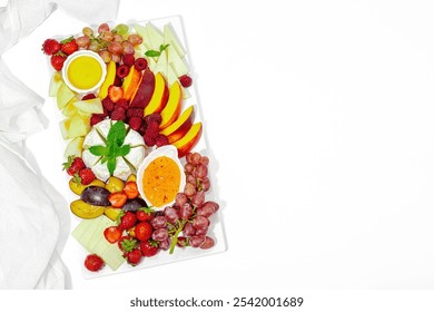 Assorted cheese plate with fruits and sauces isolated on white background. Vegan snacks concept, healthy lifestyle. Wine appetizer, flat lay, top view - Powered by Shutterstock