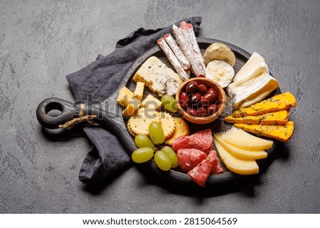 Assorted cheeses and cured meats served as a perfect accompaniment to wine, gourmet dining concept