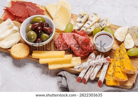 Assorted cheeses and cured meats served as a perfect accompaniment to wine, gourmet dining concept