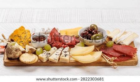 Assorted cheeses and cured meats served as a perfect accompaniment to wine, gourmet dining concept