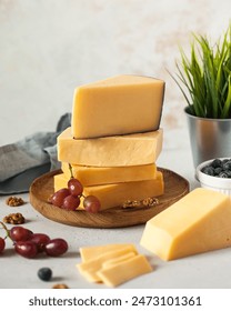 Assorted cheeses stack with fresh berries and nuts on table