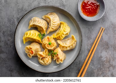 Assorted Chinese dim sum dumplings stuffed with meat and shrimps and sweet sauces. Jiao zi, shao mai, niu rou jiao with saffron and beef filling.  Asian food.  - Shutterstock ID 2203612761