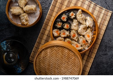 Assorted Chinese Dimsum In Bamboo Basket. Dimsum Is A Large Range Of Small Dishes That Cantonese People Traditionally Enjoy In Restaurants For Breakfast And Lunch.