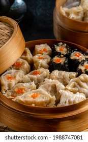 Assorted Chinese Dimsum In Bamboo Basket. Dimsum Is A Large Range Of Small Dishes That Cantonese People Traditionally Enjoy In Restaurants For Breakfast And Lunch.