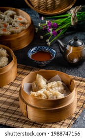 Assorted Chinese Dimsum In Bamboo Basket. Dimsum Is A Large Range Of Small Dishes That Cantonese People Traditionally Enjoy In Restaurants For Breakfast And Lunch.