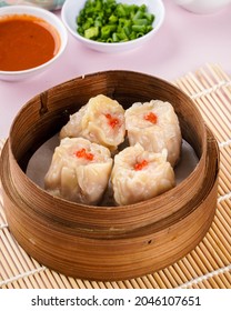 Assorted Chinese Dimsum In Bamboo Basket. Dimsum Is A Large Range Of Small Dishes That Cantonese People Traditionally Enjoy In Restaurants For Breakfast And Lunch.