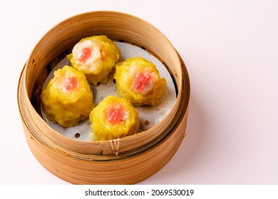 Assorted Chinese Dimsum In Bamboo Basket. Dimsum Is A Large Range Of Small Dishes That Cantonese People Traditionally Enjoy In Restaurants For Breakfast And Lunch.