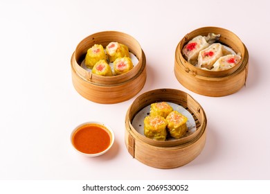 Assorted Chinese Dimsum In Bamboo Basket. Dimsum Is A Large Range Of Small Dishes That Cantonese People Traditionally Enjoy In Restaurants For Breakfast And Lunch.