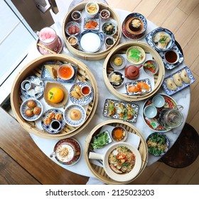 Assorted Chinese Food Full Set. Chinese Noodles, Fried Rice, Dumplings, Peking Duck, Dim Sum, Spring Rolls. Famous Chinese Cuisine Dishes On Table. Top View. Chinese Restaurant. Asian Style Banquet