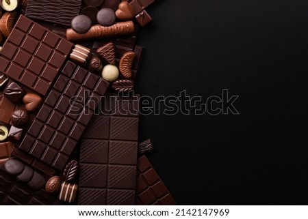 assorted chocolate bars and candy with copy space.