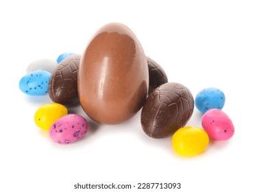 Assorted chocolate easter eggs and colorful candy eggs for holiday celebration and springtime festivities, the sweet treats represent springtime festivities and traditional gifts