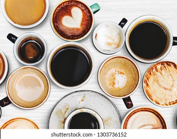 Assorted coffee cups on a textured background - Shutterstock ID 1303736152