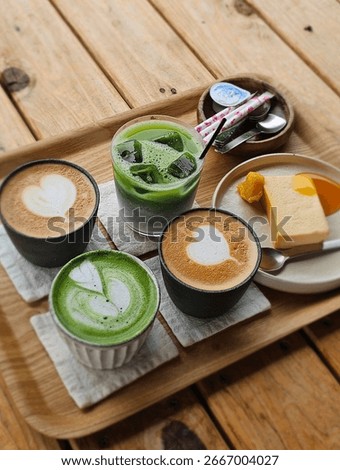 Assorted coffee and matcha drinks with dessert on wooden table 