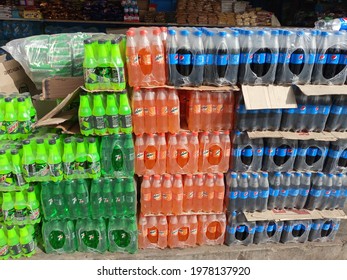 Assorted Cold drink stack wrapped in plastic, at a shop including Pepsi, Mirinda, 7up, and mountain dew - Karachi Pakistan - May 2021