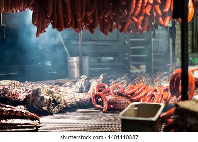 Assorted Colorful Texas Style Spicy Bbq Pit Smoked Sausages And Meats Ribs Sauce Over Wood Flame