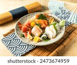 Assorted Comprehensive Sashimi with Dory sashimi, salmon sashimi, Tuna fish, swordfish served in plate isolated on napkin side view on wooden background of Japanese food