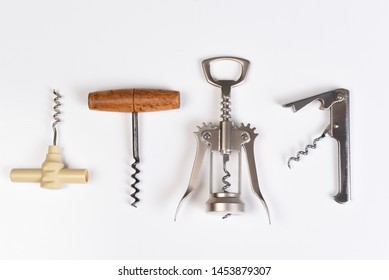 Assorted corkscrews on white. Four different styles of wine openers in a row.