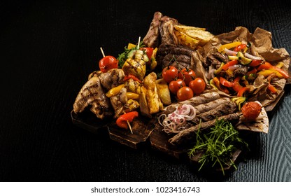 Assorted Delicious Grilled Meat With Vegetable. Mixed Grilled Bbq Meat With Vegetables. Mixed Grilled Meat On Wooden Platter. Copyspace.