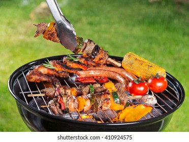 Assorted delicious grilled meat with vegetable on a barbecue grill. - Shutterstock ID 410924575