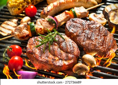 Assorted delicious grilled meat with vegetables over the coals on a barbecue - Shutterstock ID 272736689